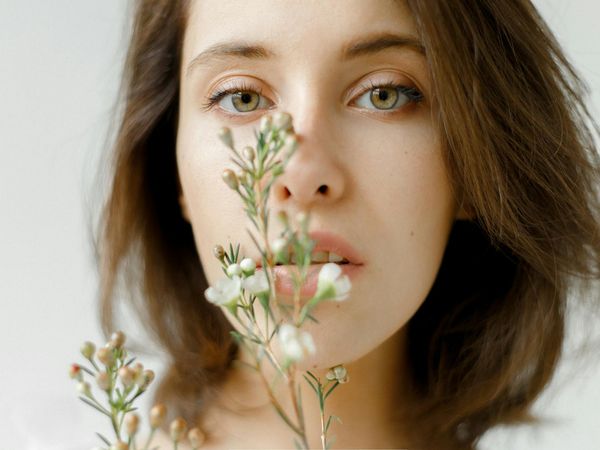 Close-up of a person's serene face while breathing deeply.